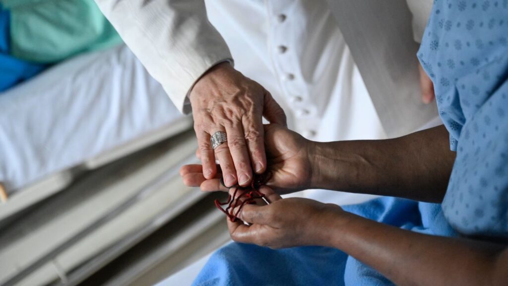 Pope Leo XIV offers a blessing to a patient at St. Paul Catholic Hospital in Douala, Cameroon, on Friday, April 17, 2026. | Credit: Vatican Media