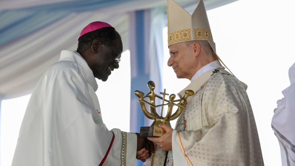 Pope Leo XIV greets Archbishop of Yaoundé Monsignor Jean Mbarga during Holy Mass at Yaoundé-Ville Airport in Cameroon, Saturday, April 18, 2026. | Credit: Vatican Media