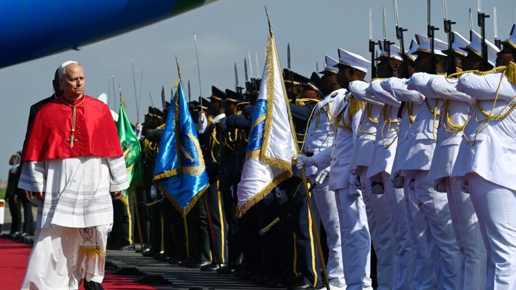Pope Leo XIV receives a ceremonial greeting upon his arrival at Quatro de Fevereiro Airport in Luanda, Angola, Saturday, April 18, 2026. | Credit: Vatican Media