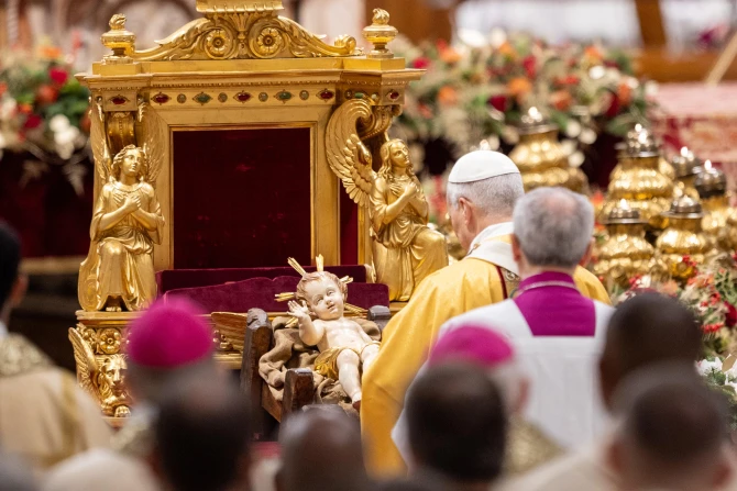 Pope Leo XIV venerates a statue of the Child Jesus during the celebration of Christmas Mass during the Night in St. Peter's Basilica on Dec. 24, 2025. | Credit: Daniel Ibanez/EWTN News