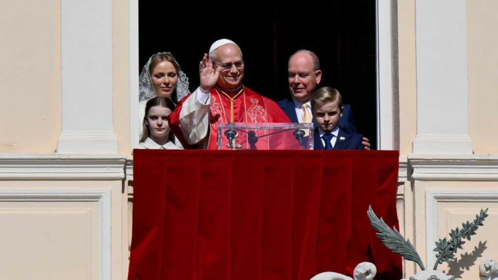 Pope Leo XIV waves after his speech from the balcony next to Prince Albert II of Monaco and Princess Charlene of Monaco at the Prince's Palace of Monaco in Monte Carlo, Monaco, on Saturday, March 28, 2026. | Credit: Vatican Media