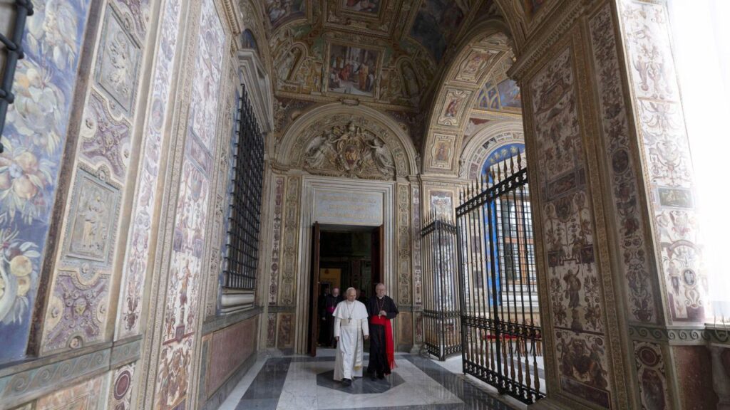 Pope Leo XIV walks in the corridor of the Third Loggia of the Apostolic Palace where the papal apartment is located, on May 12, 2025 in Vatican City. - Credit: Vatican Media/Vatican Pool/Getty Images
