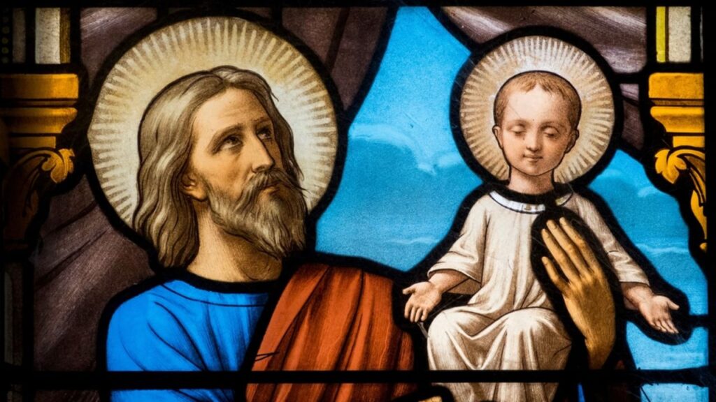 Stained glass (19th century) of St. Joseph holding baby Jesus Christ in his arms, Myans, France. | Credit: Joan Sutter/Shutterstock