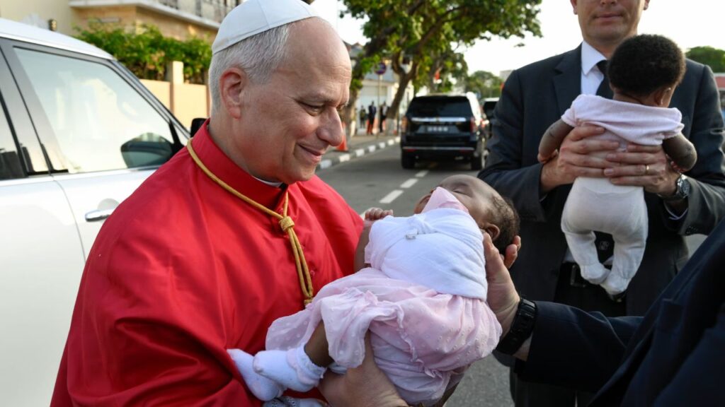 Pope Leo XIV holds a baby during his visit to the apostolic nunciature in Angola on April 20, 2026. | Credit: Vatican Media