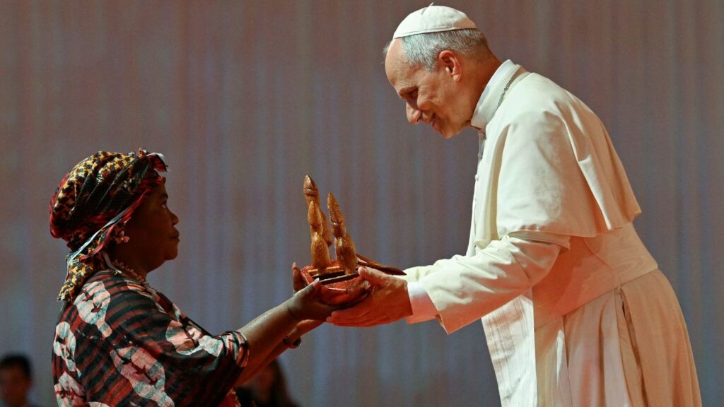 Pope Leo XIV receives a gift from a woman while meeting with families at Bata Stadium in Equatorial Guinea, Wednesday, April 22, 2026. | Credit: Vatican Media