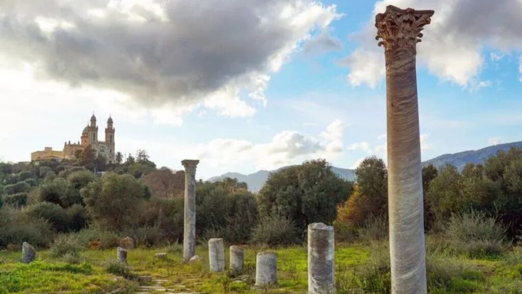 The Roman ruins of the ancient city of Hippo stand in the foreground, with the Basilica of St. Augustine rising in the background in Annaba, Algeria. (photo: Makrouf Walid / Shutterstock)