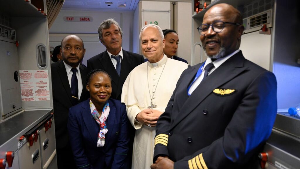 Pope Leo XIV stands with airline staff en route to Mengomeyén, Equatorial Guinea, Wednesday, April 22, 2026. | Credit: Vatican Media