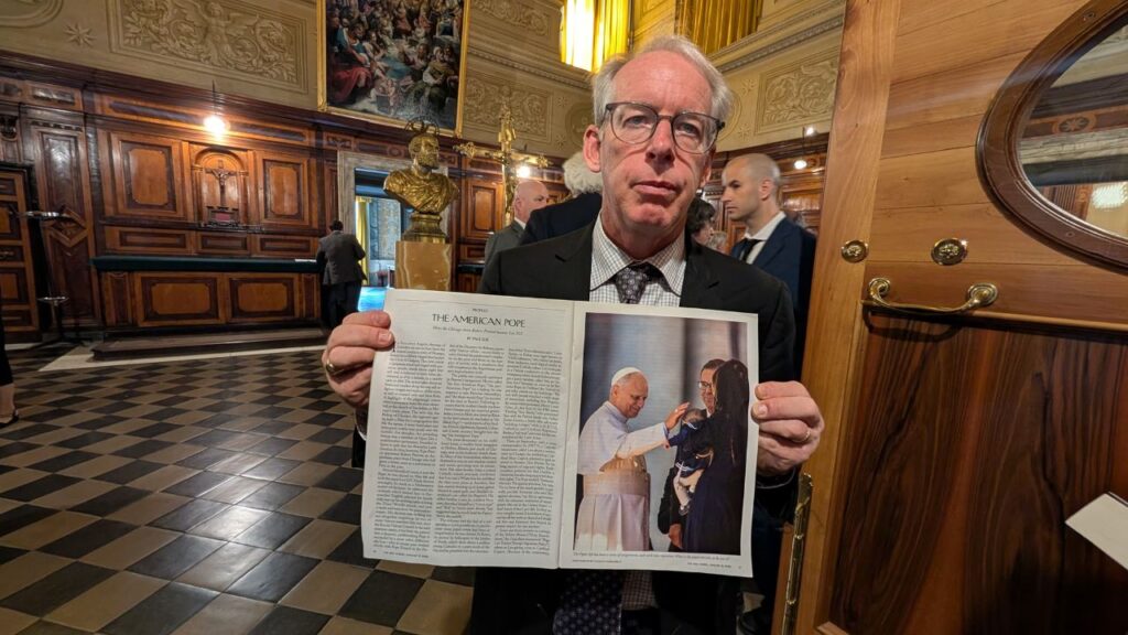 Paul Elie, an American author and senior fellow at Georgetown University, holds up his New Yorker article on Pope Leo XIV in a sacristy of Saint Peterʼs Basilica in the Vatican on June 24, 2026. | Credit: Ishmael Adibuah/EWTN News