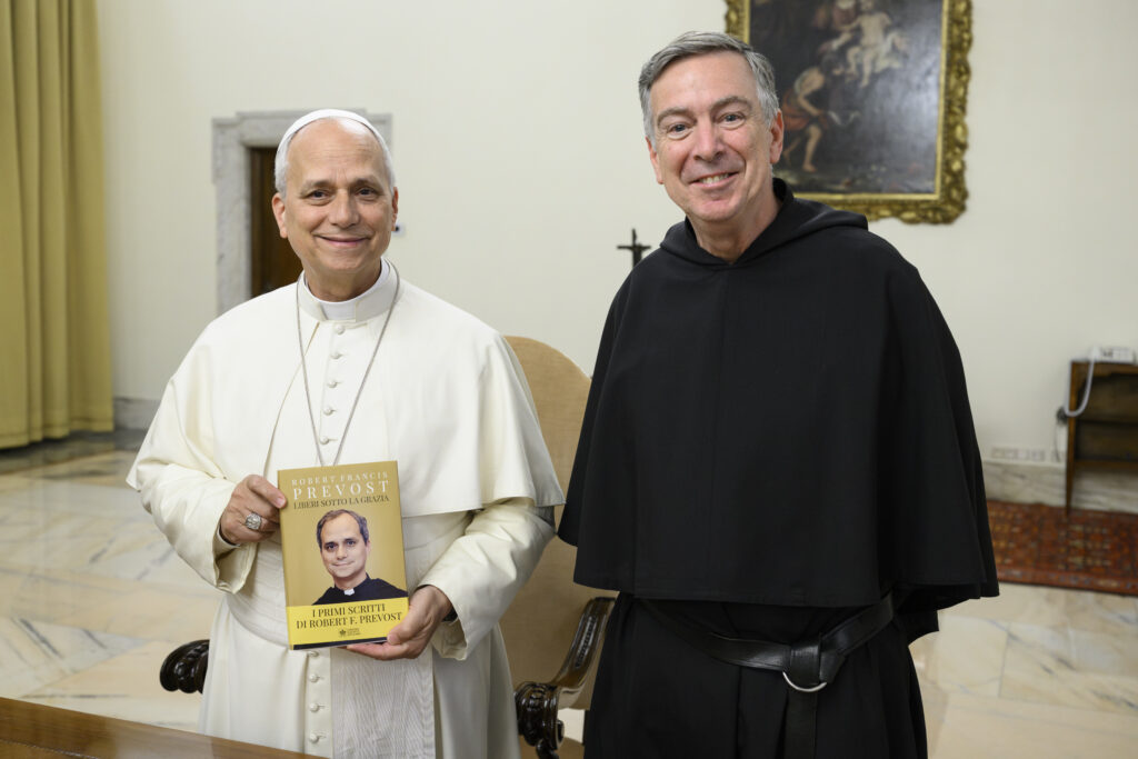 Father Joseph Farrell, prior general of the Order of St. Augustine, presents Pope Leo XIV with a newly published anthology of his pre-papal writings, at the Vatican on May 4, 2026. | Credit: Vatican Media