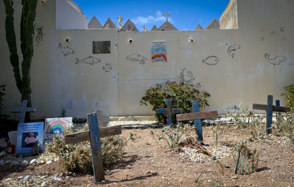 A cemetery on the Italian island of Lampedusa, where on July 4, 2026, Pope Leo XIV will visit the graves of migrants and refugees who died while trying to cross the Mediterranean Sea. Crosses made from the wood of shipwrecked boats mark the graves of children. | Credit: Tiziana Fabi via Getty Images