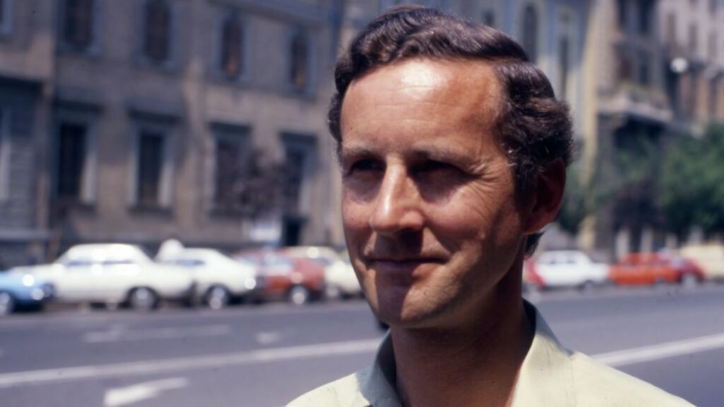 David Willey, who died July 11, 2026, served as a BBC correspondent in Rome starting in 1972. He is seen here standing on a street in 1980. | Credit: Photo courtesy of BBC