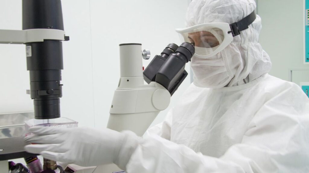 A researcher looks through a microscope in one of the research laboratories of the Bambino Gesù Pediatric Hospital. | Credit: Bambino Gesù Pediatric Hospital