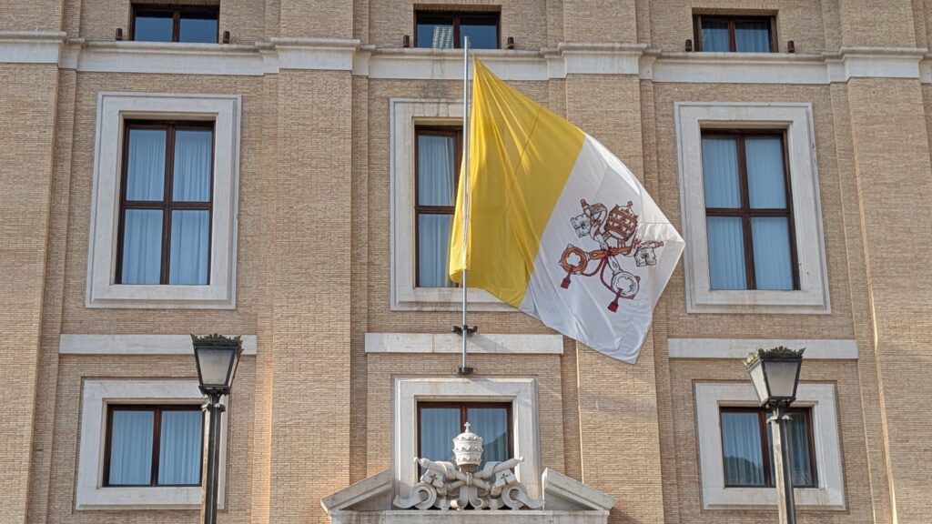 A flag of Vatican City State flies outside Piazza Pio XII, the main entrance to St. Peter’s Square, on July 16, 2026. | Credit: Ishmael Adibuah/EWTN News