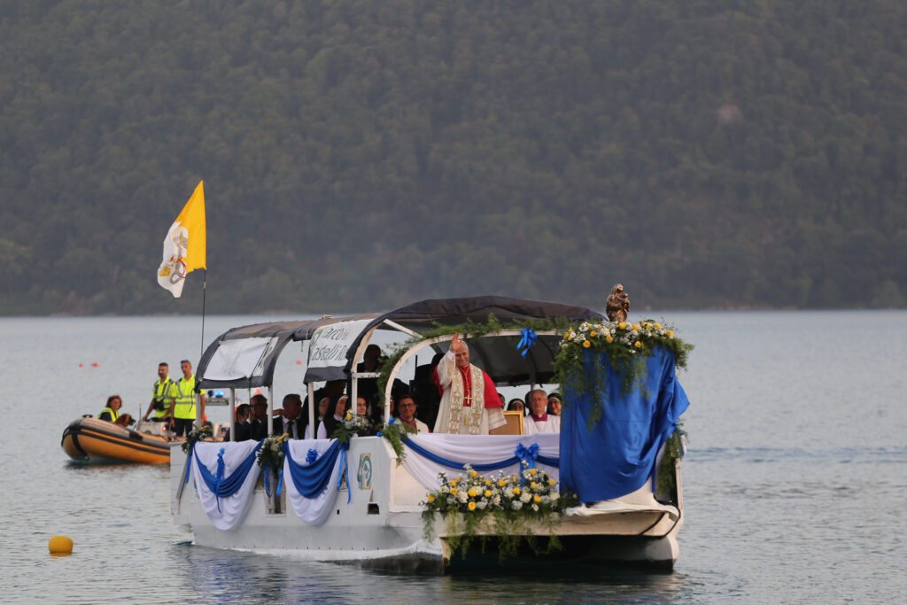Pope Leo XIV travels across Lake Albano, Castel Gandolfo, Aug. 29, 2026. Leo took part in a Marian procession on the lake, becoming the first pope to travel by boat across the waters there according to the Vatican. | Credit: Zofia Czubak/EWTN News