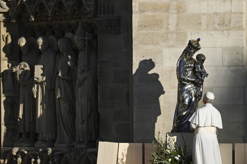 Pope Leo XIV stands outside Notre-Dame Cathedral in Paris on Sept. 25, 2026 to pray the Salve Regina before the statue of Our Lady and the Infant Jesus. Commissioned in the early 19th century and crafted by goldsmith Charles-Nicolas Odiot, the statue survived being thrown from the archbishop's palace during the riots of 1831 and later narrowly escaped being melted down. | Credit: Vatican Media