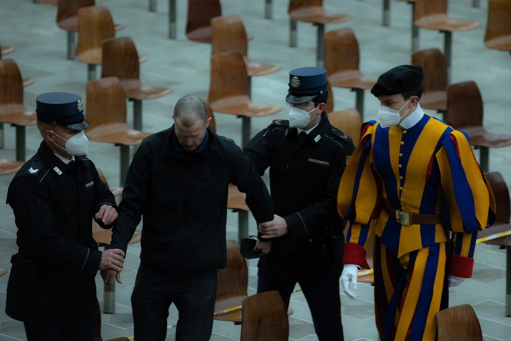 Vatican gendarmes and a Swiss Guard remove a man from the Paul VI Hall of the Vatican after he shouted at Pope Francis during the general audience on Feb. 2, 2022. | Credit: Daniel Ibáñez/EWTN News