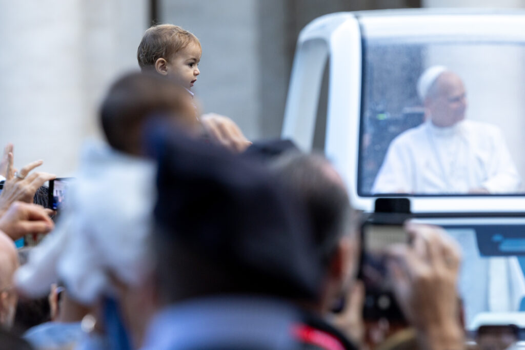 A child is held up for Pope Leo XIV to bless when he passes by in the popemobile during the general audience in St. Peter’s Square on Oct. 21, 2026. | Credit: Daniel Ibáñez/EWTN News