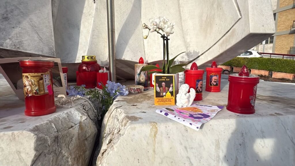 A photo of Pope Leo XIV surrounded by candles placed by the faithful outside Gemelli Hospital. | Credit: Victoria Cardiel/EWTN News.