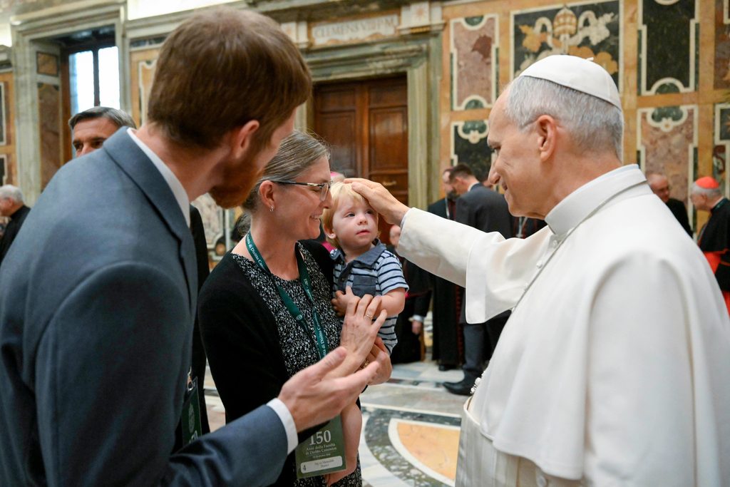 Pope Leo XIV blesses the child of participants in an international congress organized by the Faculty of Canon Law of the Pontifical Gregorian University at the Vatican on Oct. 23, 2026. | Credit: Vatican Media